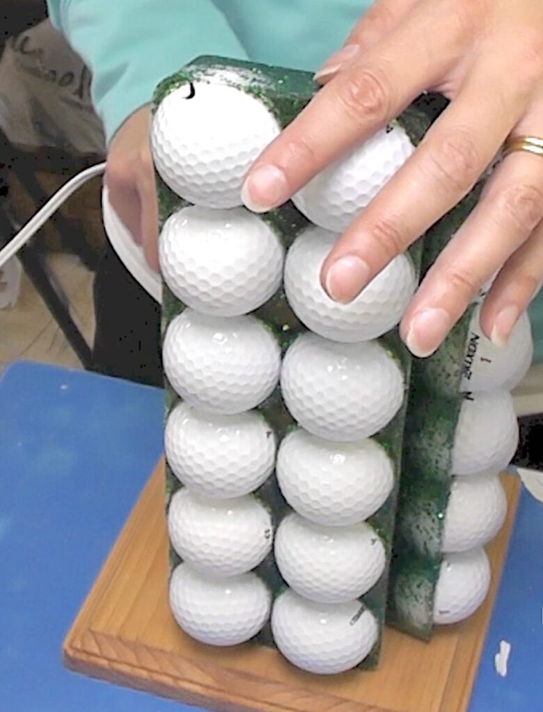 Put two golf ball and resin pieces together