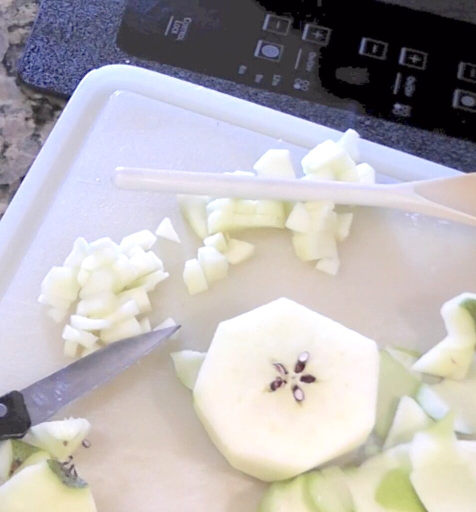 Chopped apples on cutting board with knife