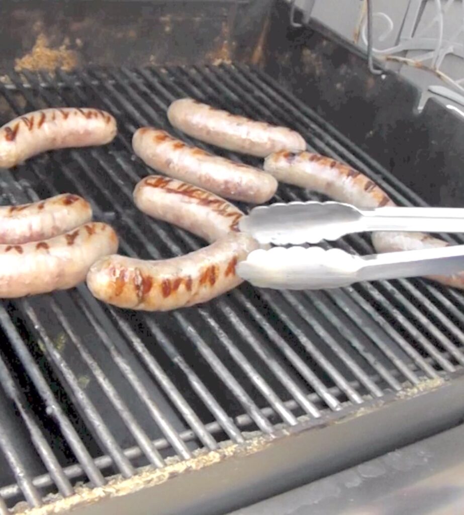 Cooking brats on grill for beer brats
