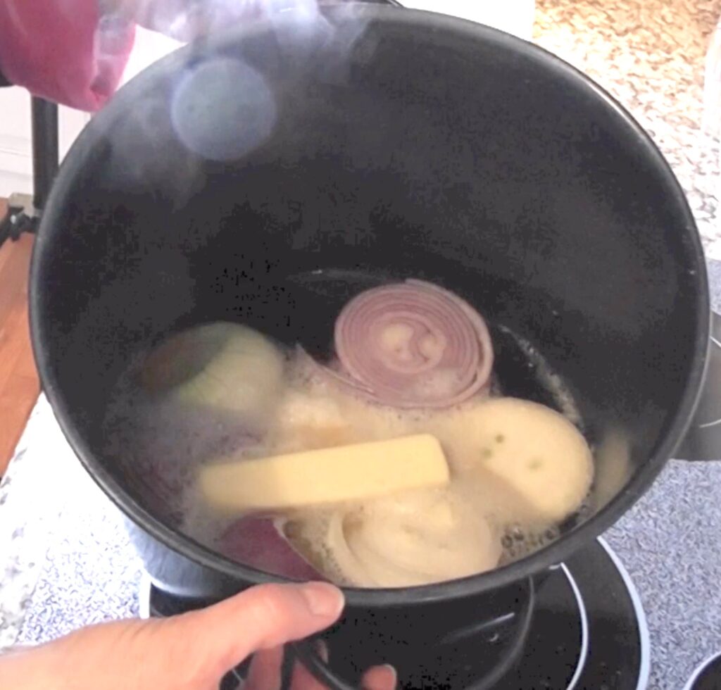 Onions, beer and butter cooking in pot