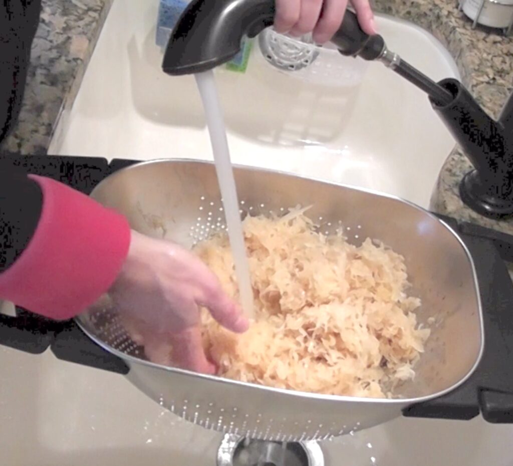 Rinsing sauerkraut in sink