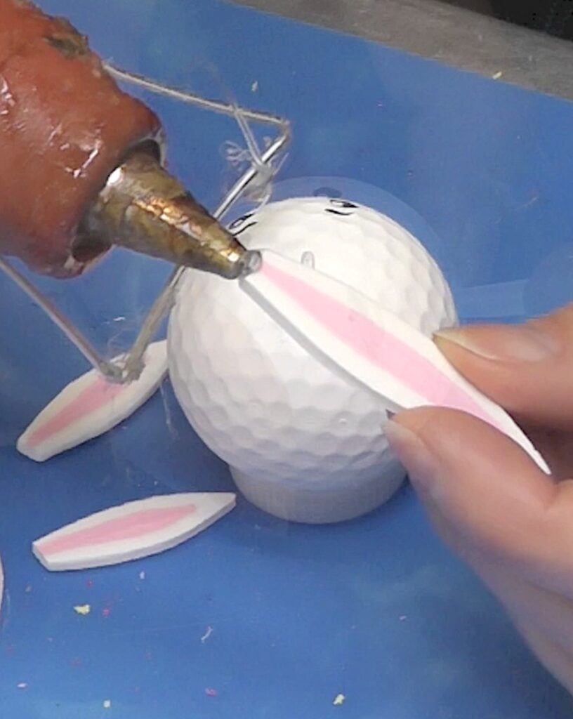 Add hot glue to edge of bunny ear