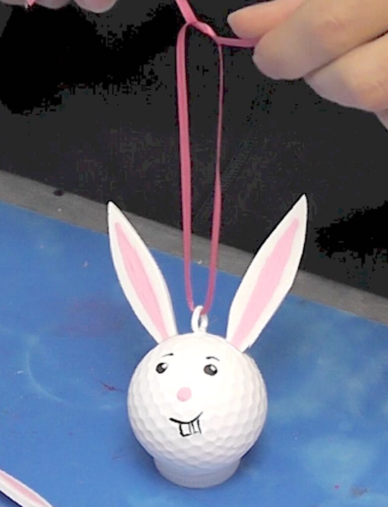 Add ribbon to hang the golf ball bunny