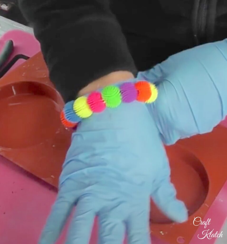 Wearing colorful koosh ball bracelet on wrist