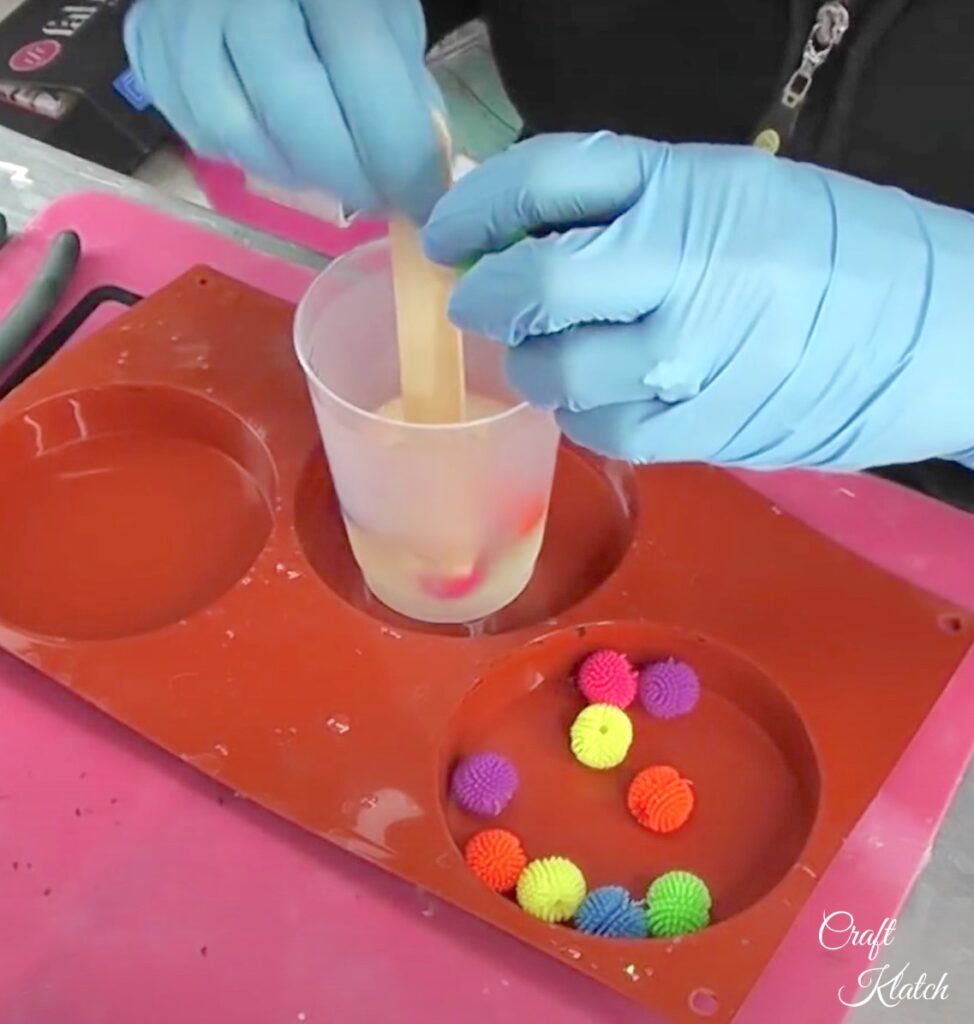 Mix resin and drop koosh balls into resin