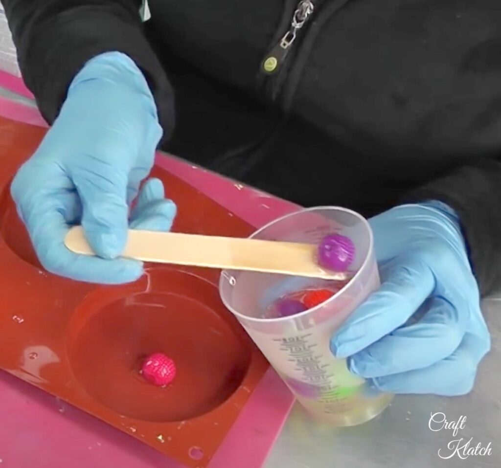 Take resin colored koosh balls and place them in coaster mold