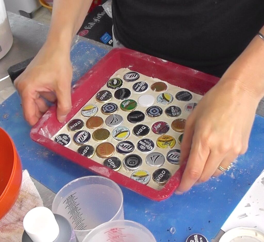 Removing concrete and beer bottle caps from square silicone mold