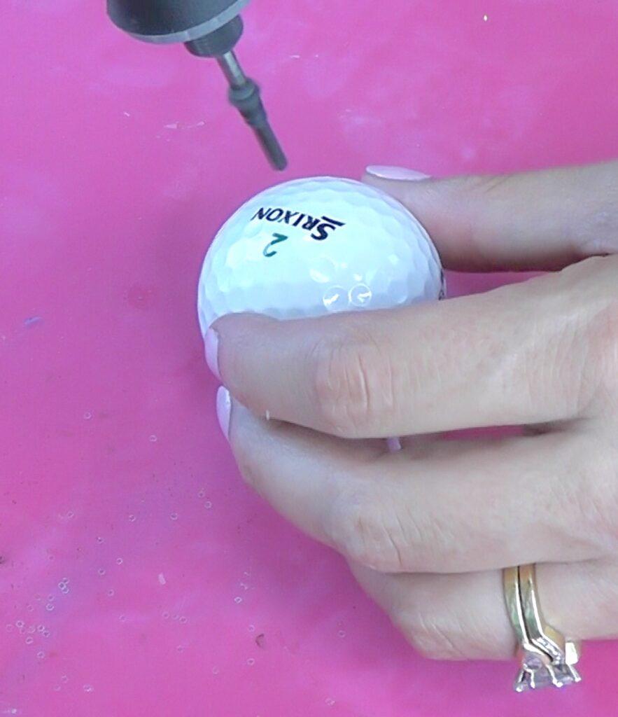 Drill a hole into a golf ball