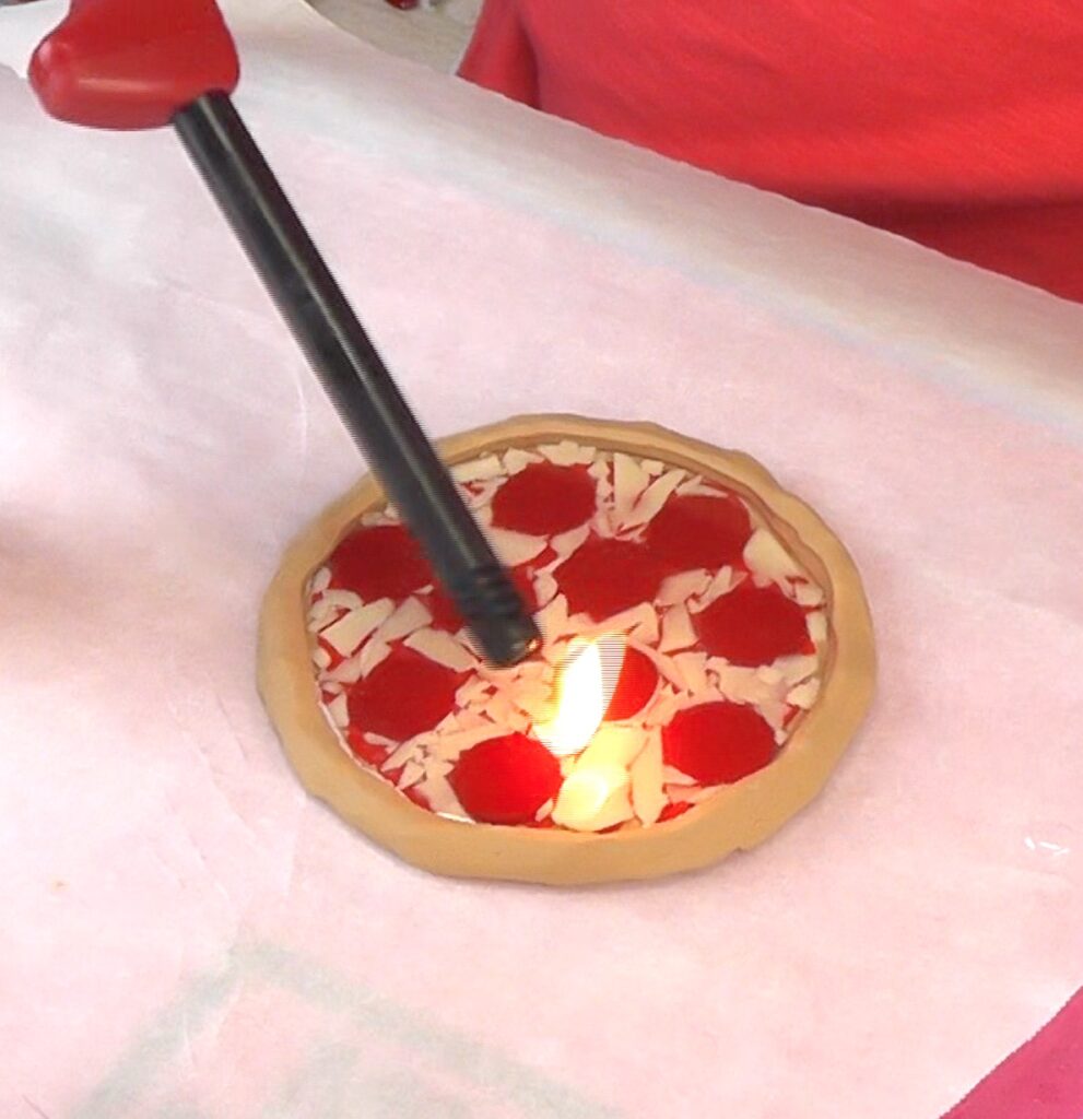 Use lighter to pop the bubbles in the resin
