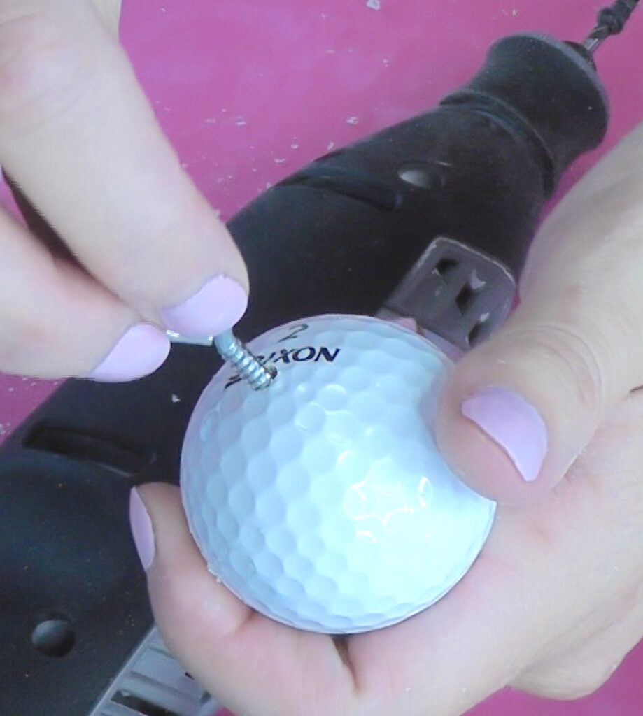 Screw and eye screw into the golf ball