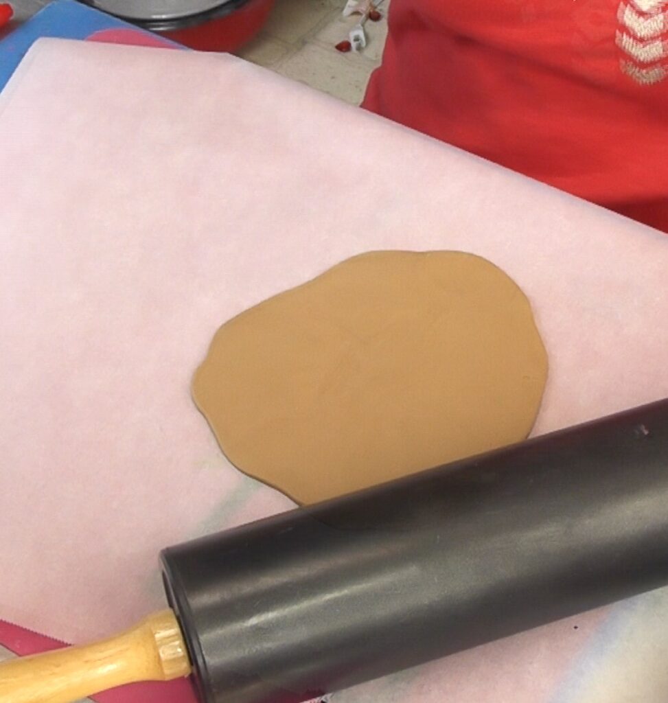 Roll the clay flat with a rolling pin