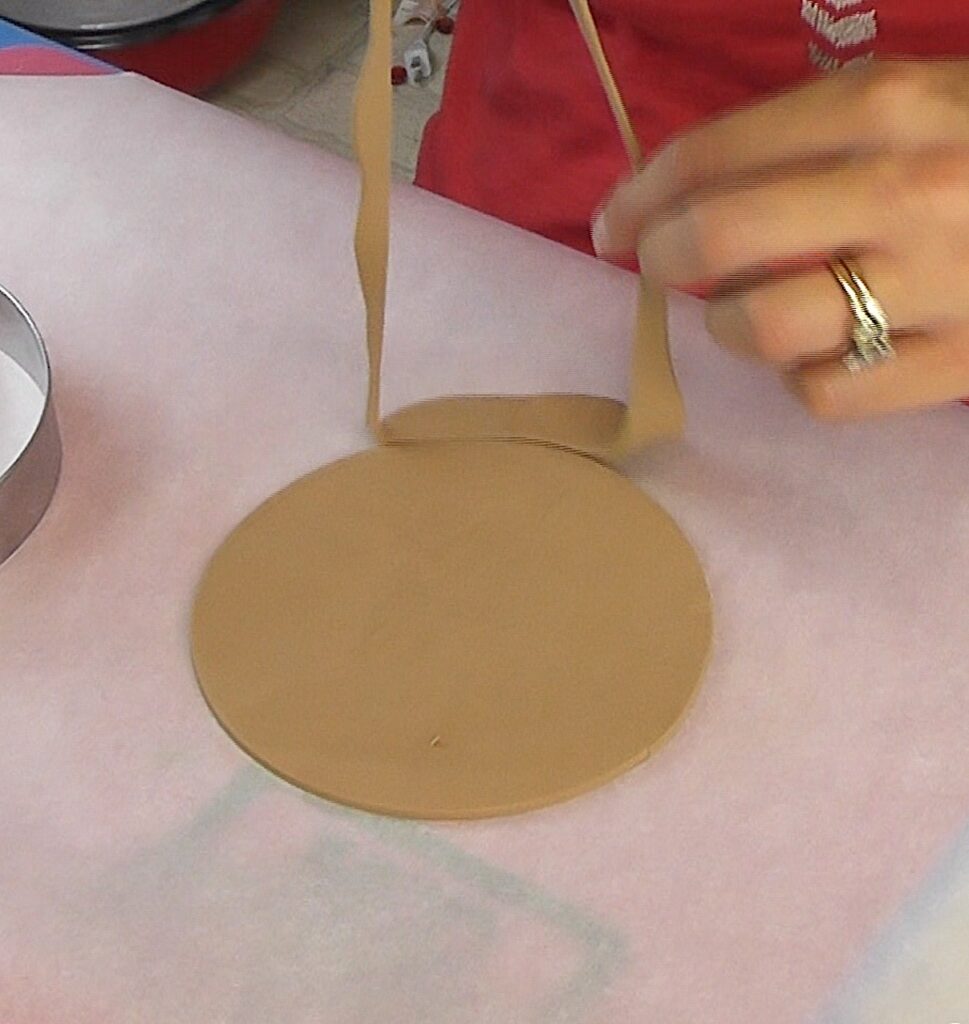 Remove the excess clay from around the circle cookie cutter