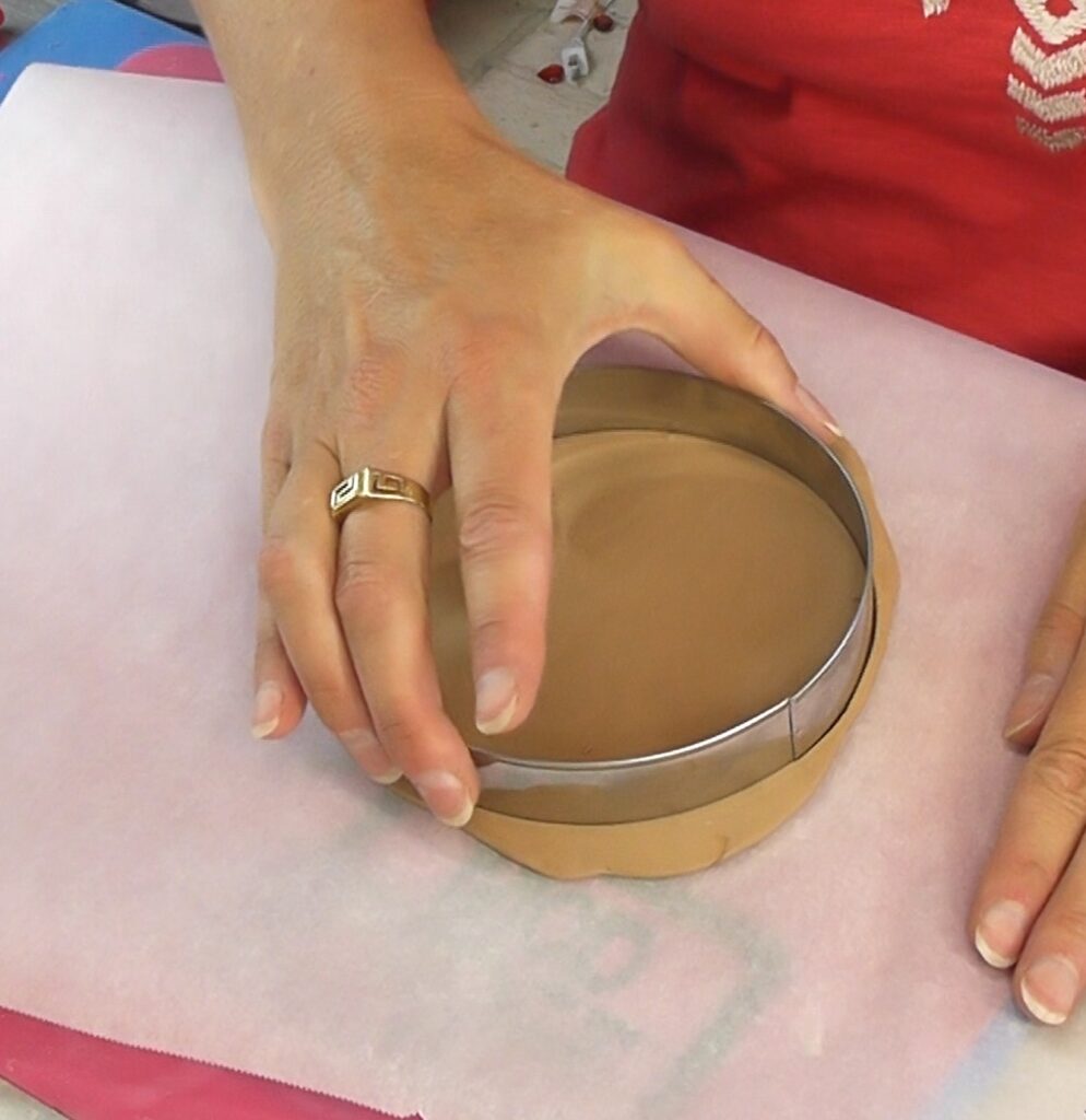 Use a large circle cookie cutter to cut out the base for the DIY Pizza craft