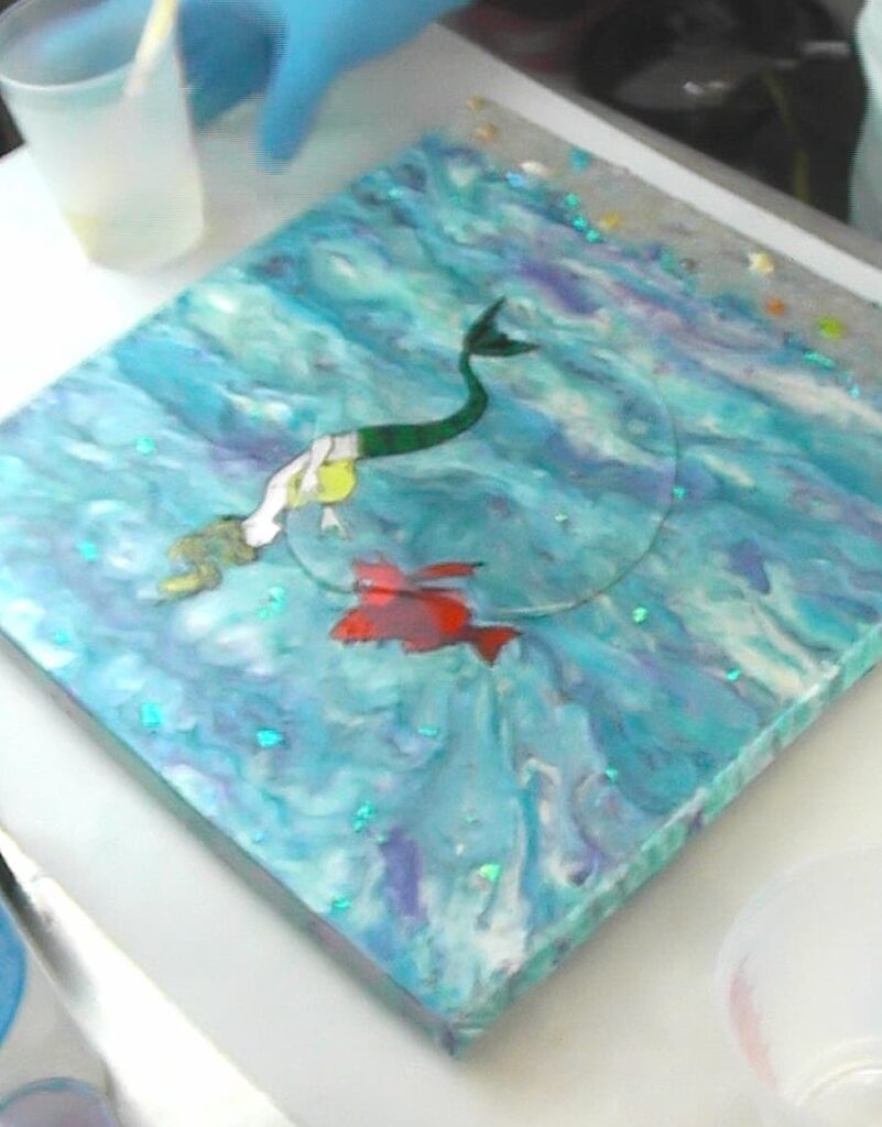Poured a puddle of resin onto the mermaid art