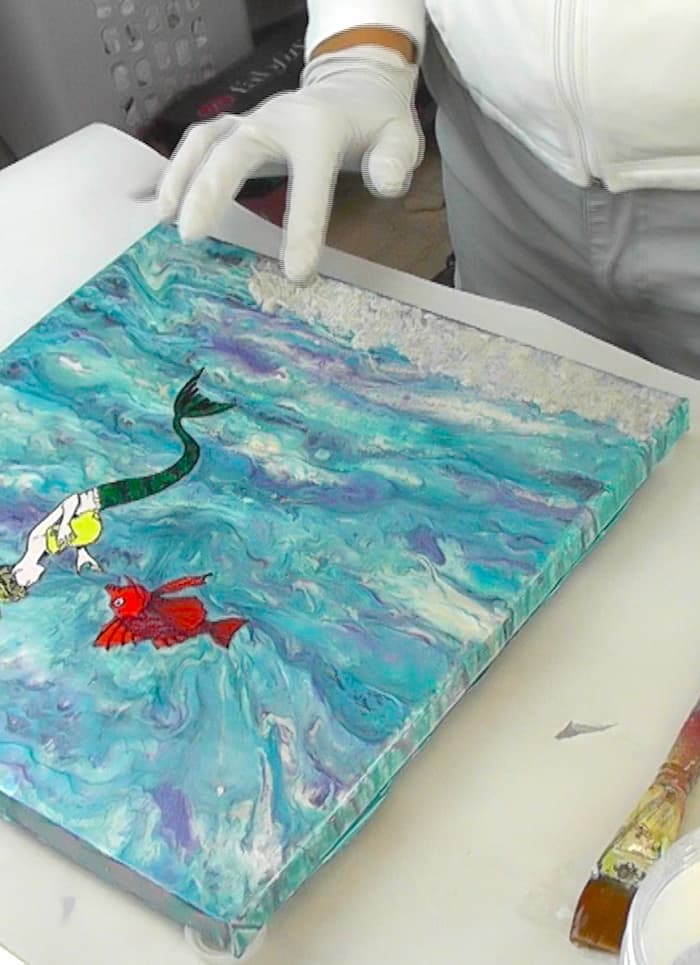Adding sand to the bottom of the mermaid mixed media art piece