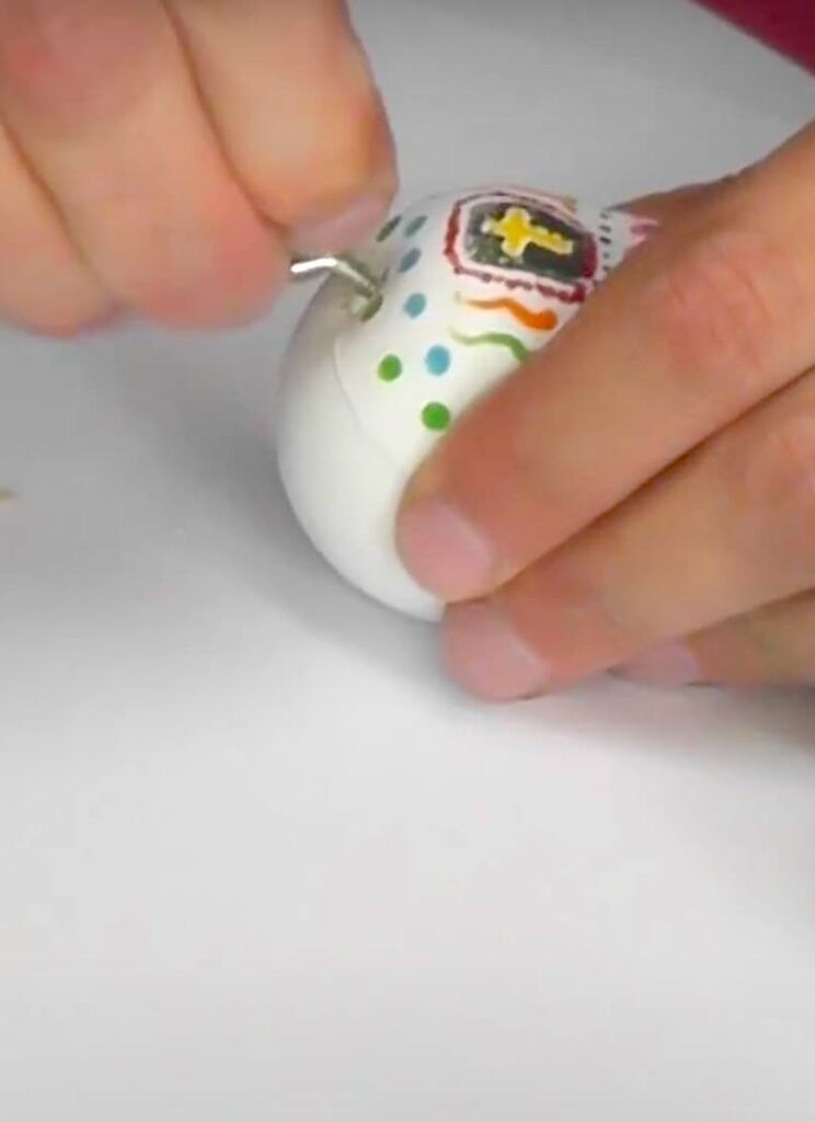 Adding the eyescrew into the top of the sugar skull day of the dead jewelry