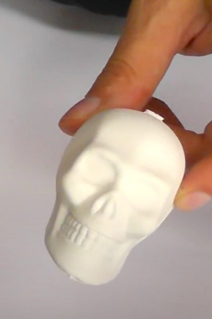 Painted white skull ready to be painted for sugar skull day of the dead jewelry