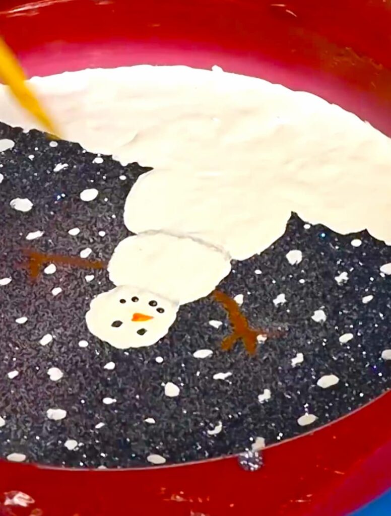 Painting on resin with a skewer stick for the snowman details