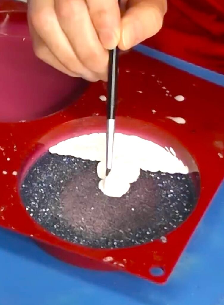 Showing how to paint on resin for a snowy scene