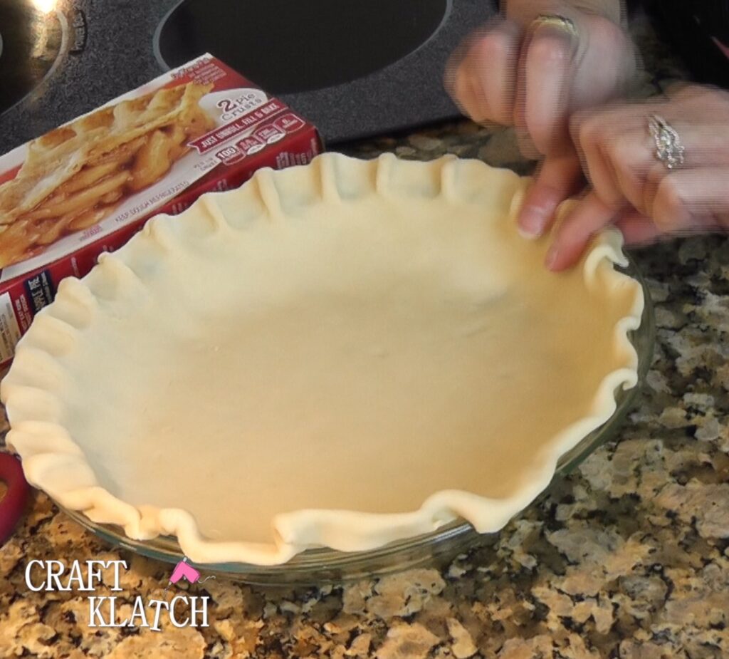 Pumpkin pie - Using fingers to flute edge of pie crust