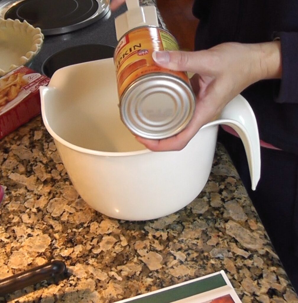 Pumpkin pie - Pouring canned pumpkin into bowl