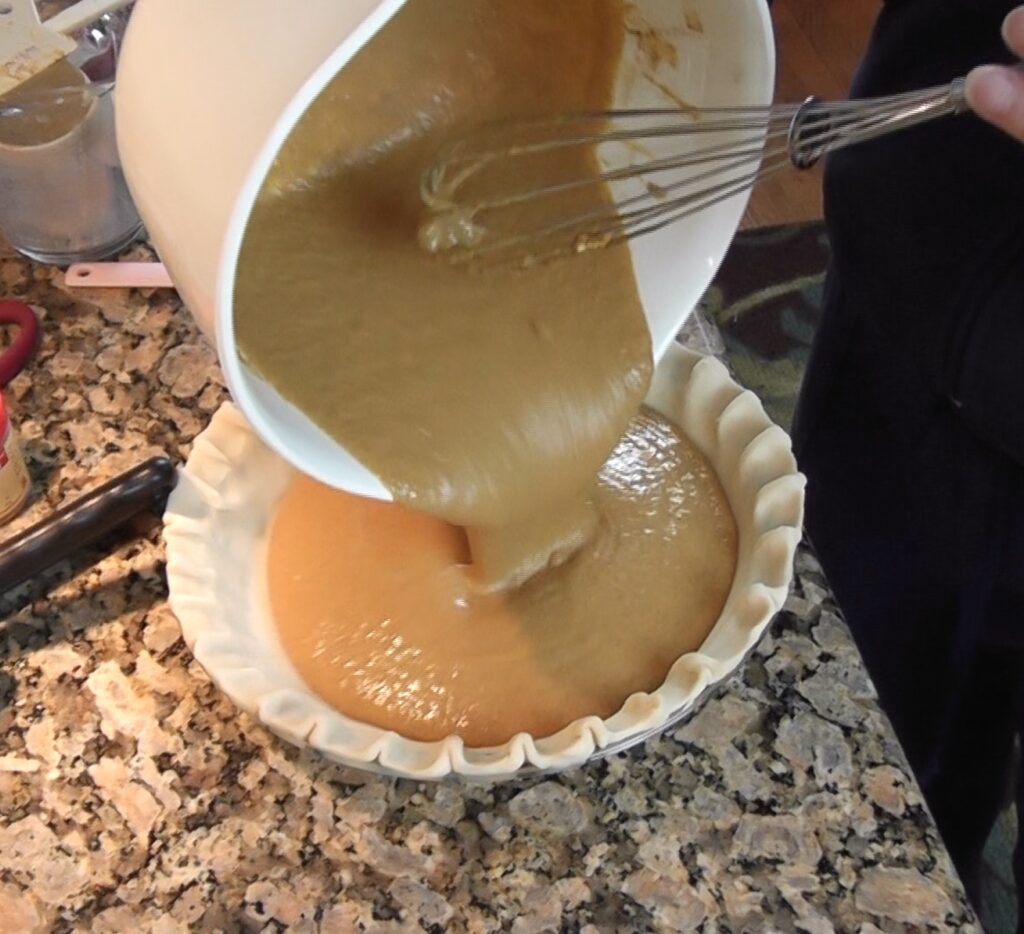 Pumpkin pie - Pouring pumpkin pie ingredients into pie crust