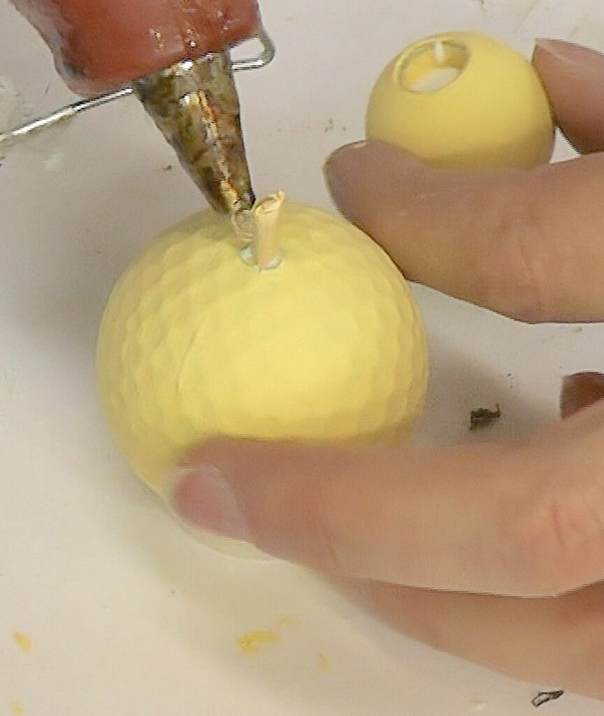 Insert skewr stick and glue into golf ball