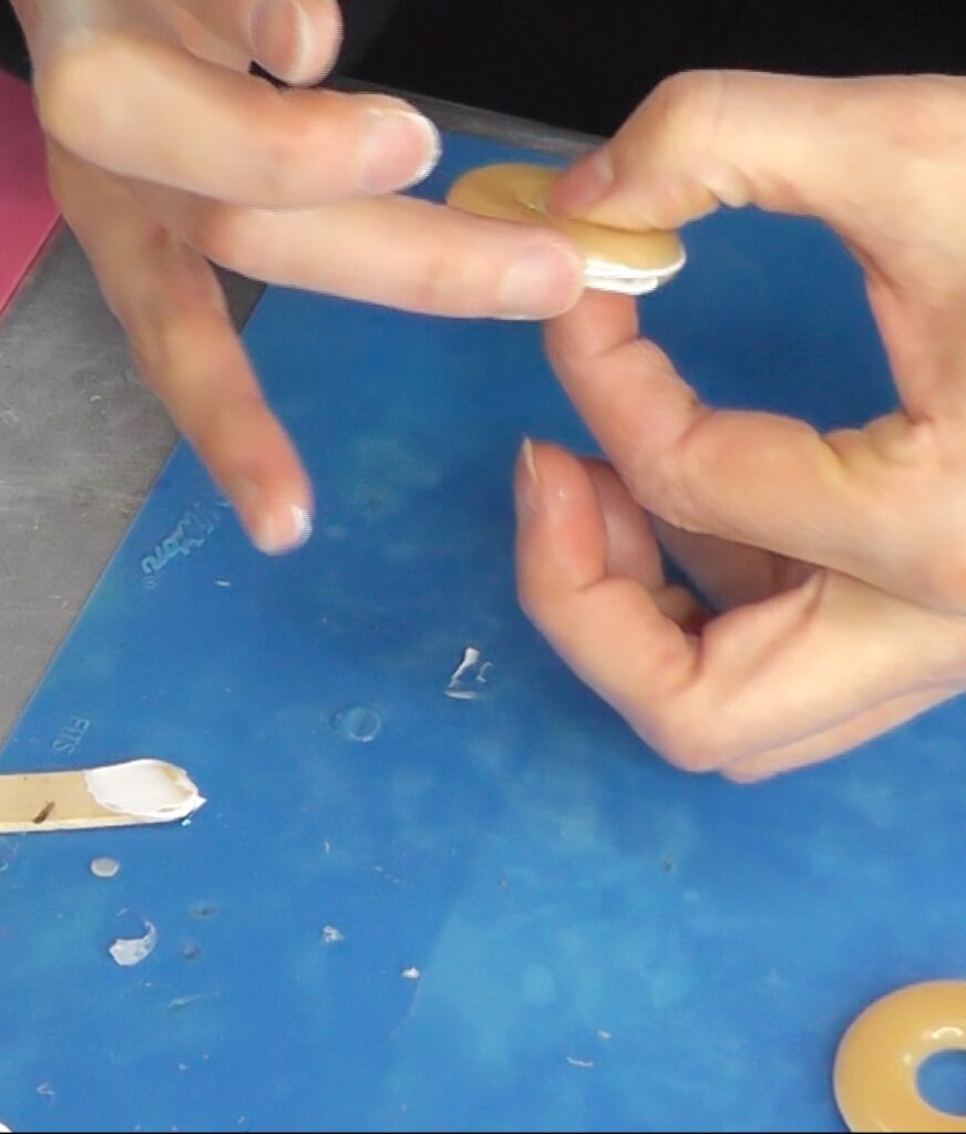 Wipe any excess glue that squishes out from in between the two donut halves