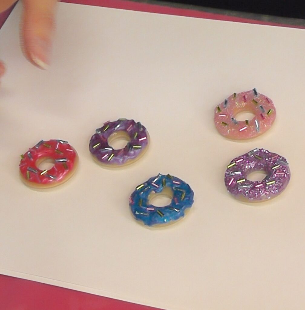 Finished donut roll jewelry with glitter, frosting and sprinkles!