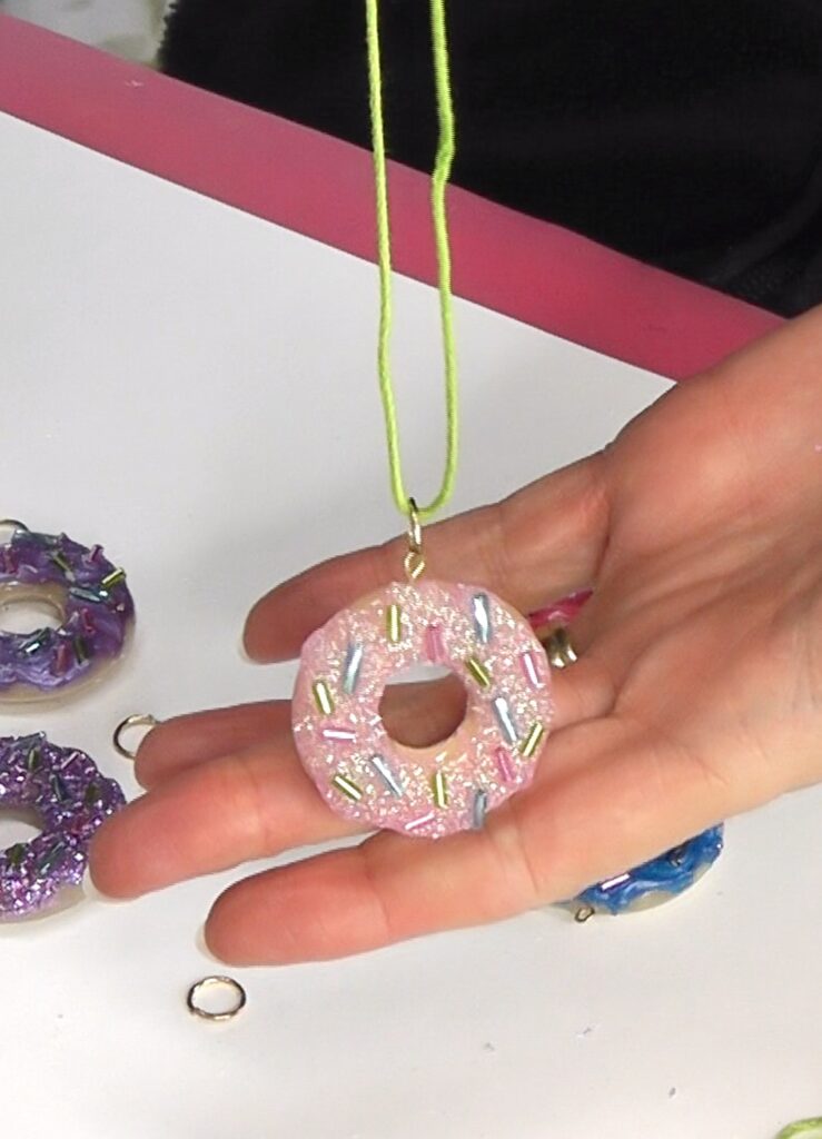 Pink donut ring jewelry with pink glittered frosting