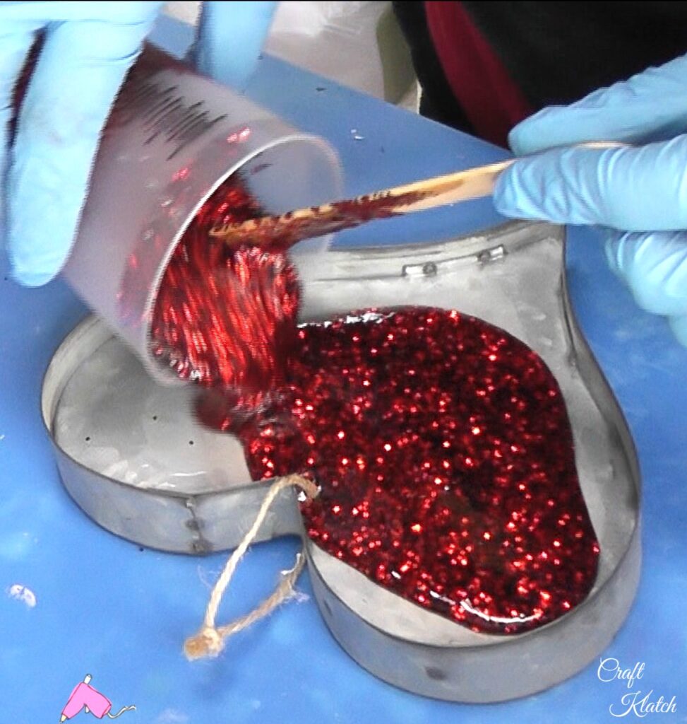 Pour red glitter resin into heart Valentine's Day ornament