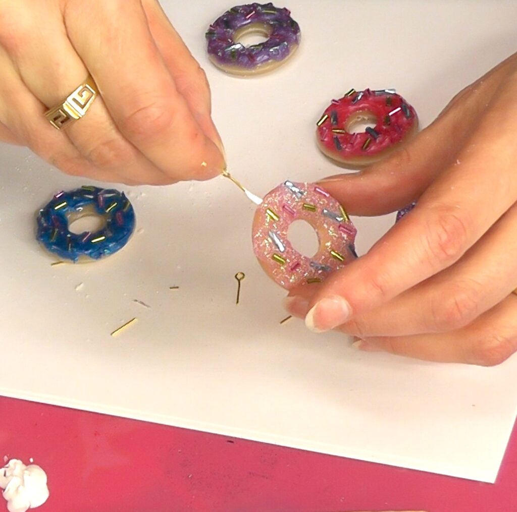 Add eye pin to resin donut