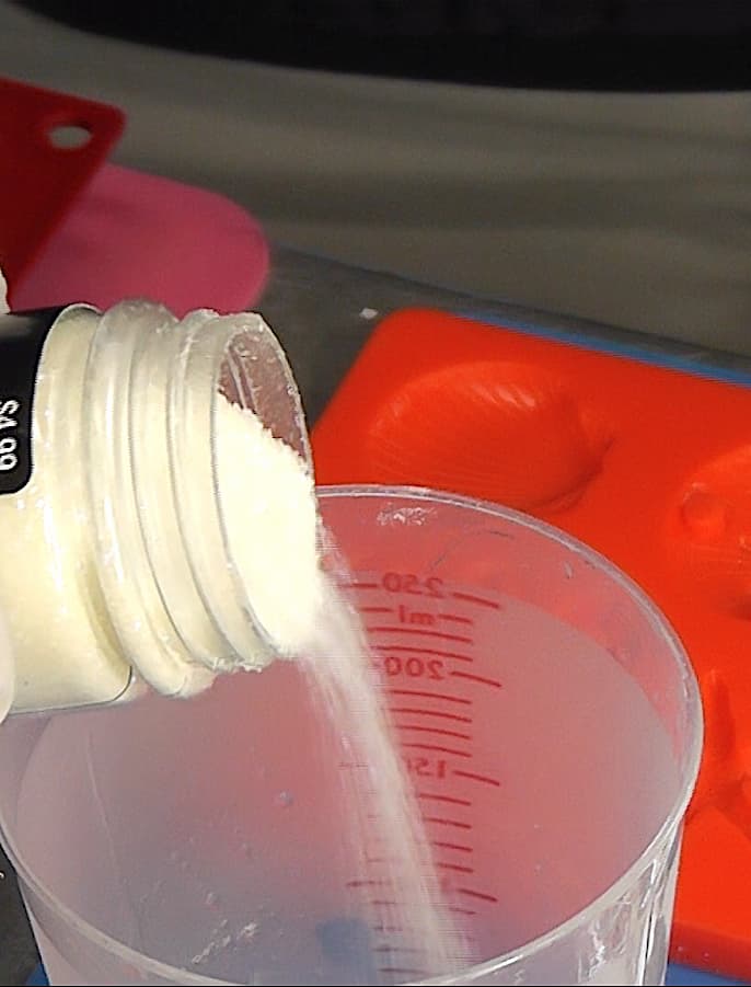 pouring glow in the dark glitter into resin