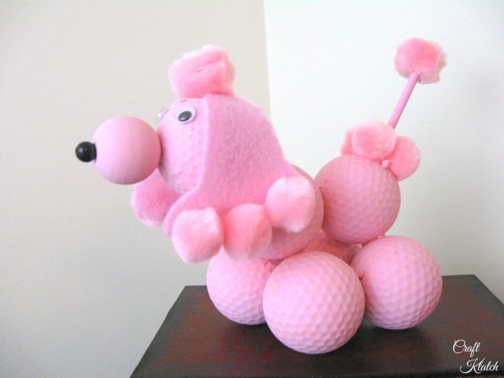 Pink poodle made out of golf balls