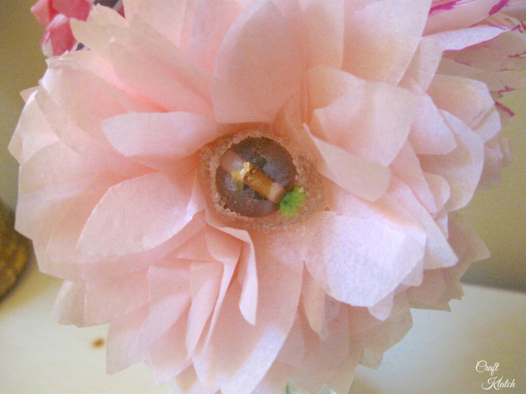 Pink tissue paper flower with bead center