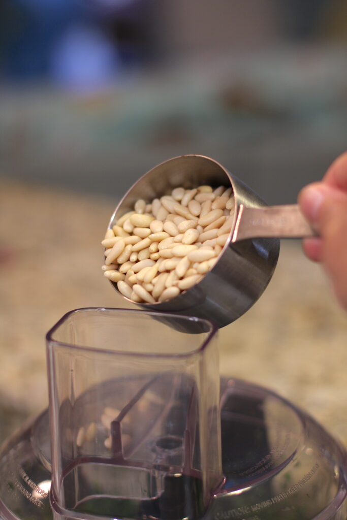 Add pine nuts in the food processor for the basil pesto recipe