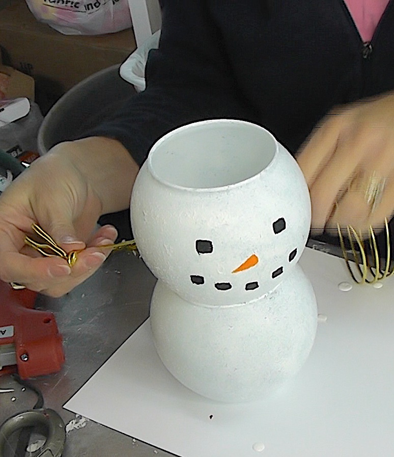 Use wire to make arms and hands for the snowman with lights