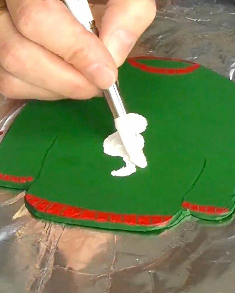 painting snowman on an ugly Christmas sweater