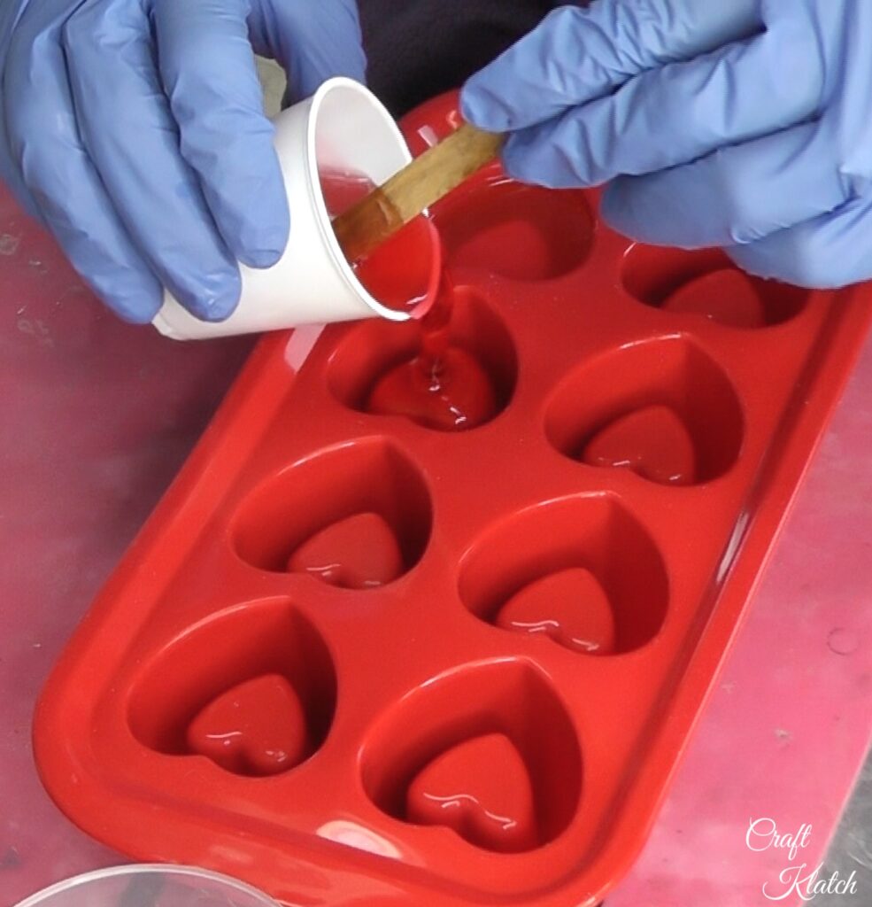 Pour resin into silicone hearts mold