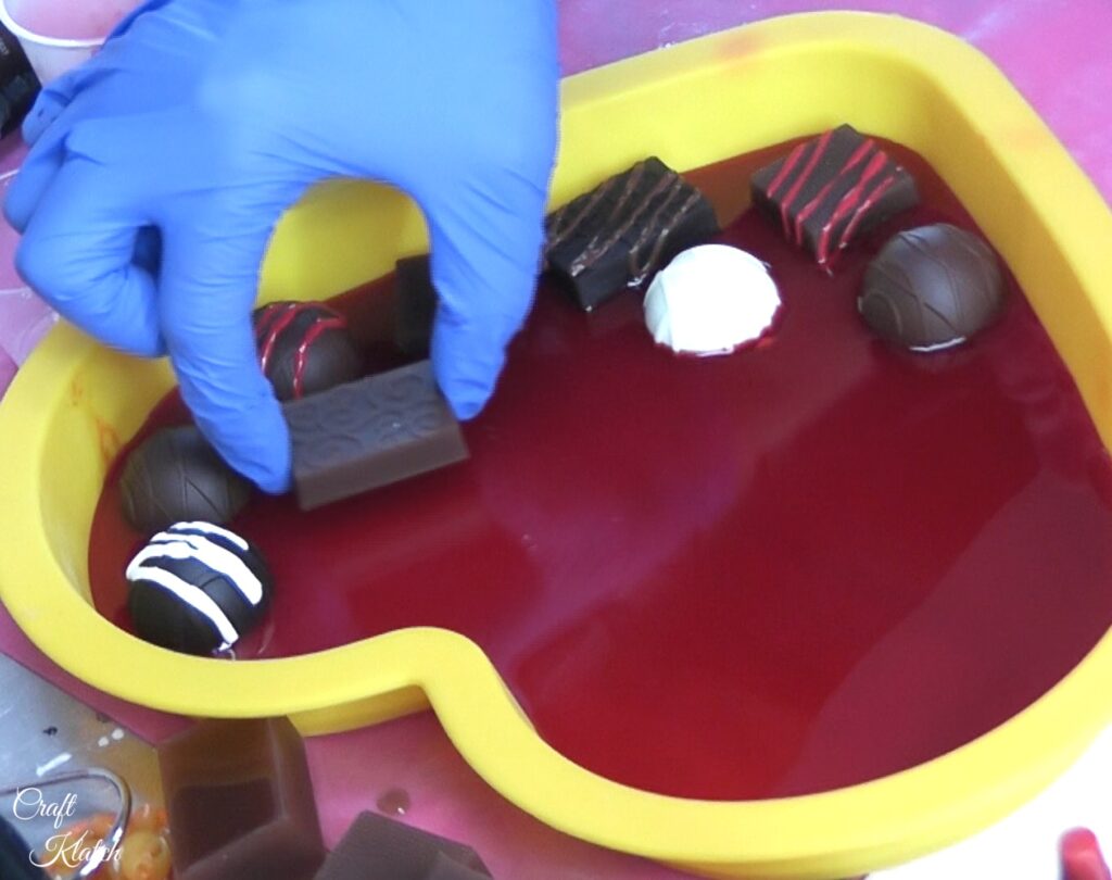 Place resin chocolates into red resin heart