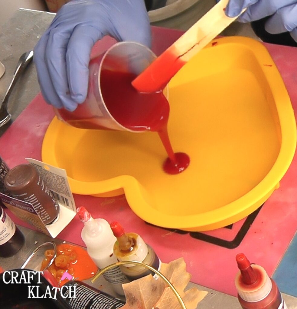 Pour red resin into yellow heart mold