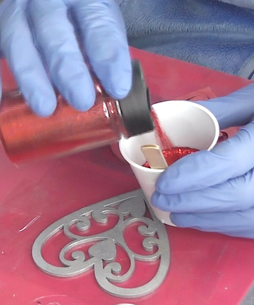 Mix fine red glitter into the resin