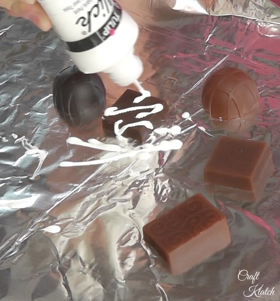 Use paint to decorate th resin chocolates