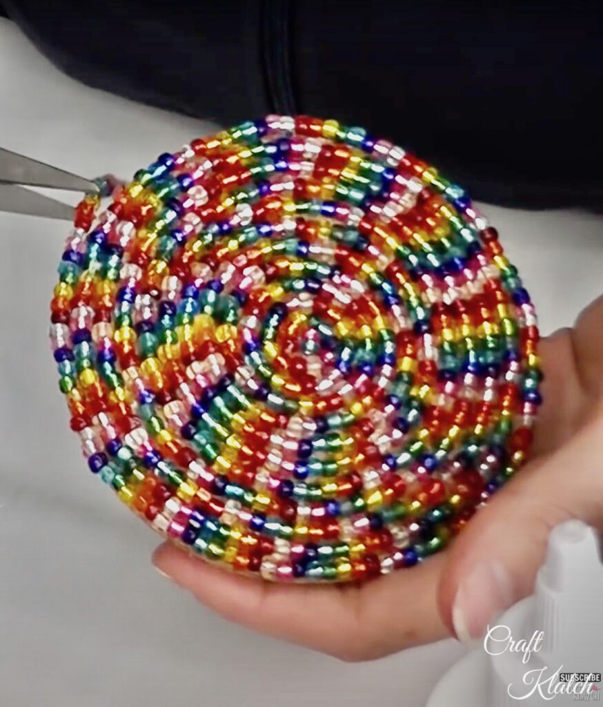 Using scissors to trim off extra beads