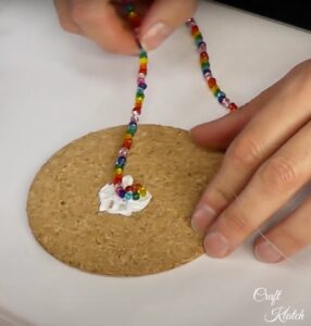 Gluing glass beads to cork round