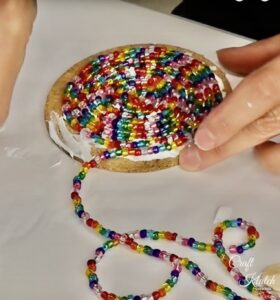 Glass beads spiraled on cork round to create glass bead coaster