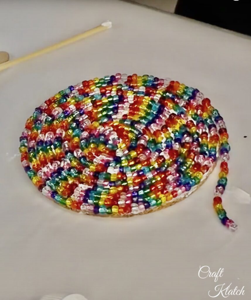 Glass beads snaked around to create a glass bead drink coaster