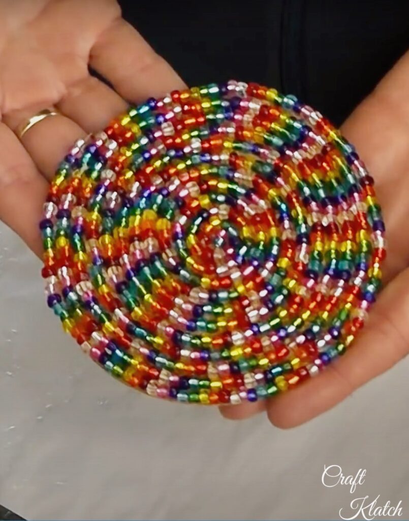 Completed glass beaded coaster with rainbow beads