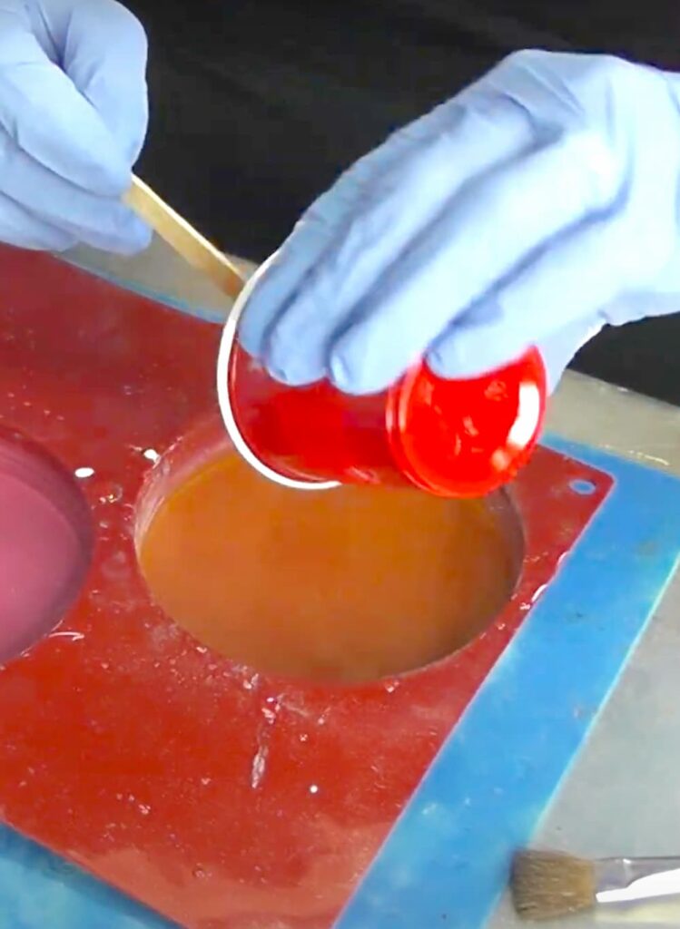 Pouring fast curing resin into coaster mold
