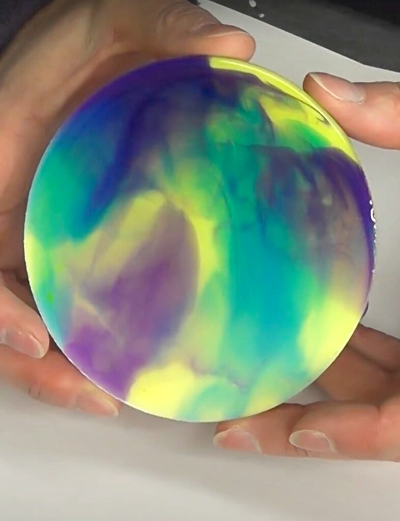 Holding finished abstract art coaster